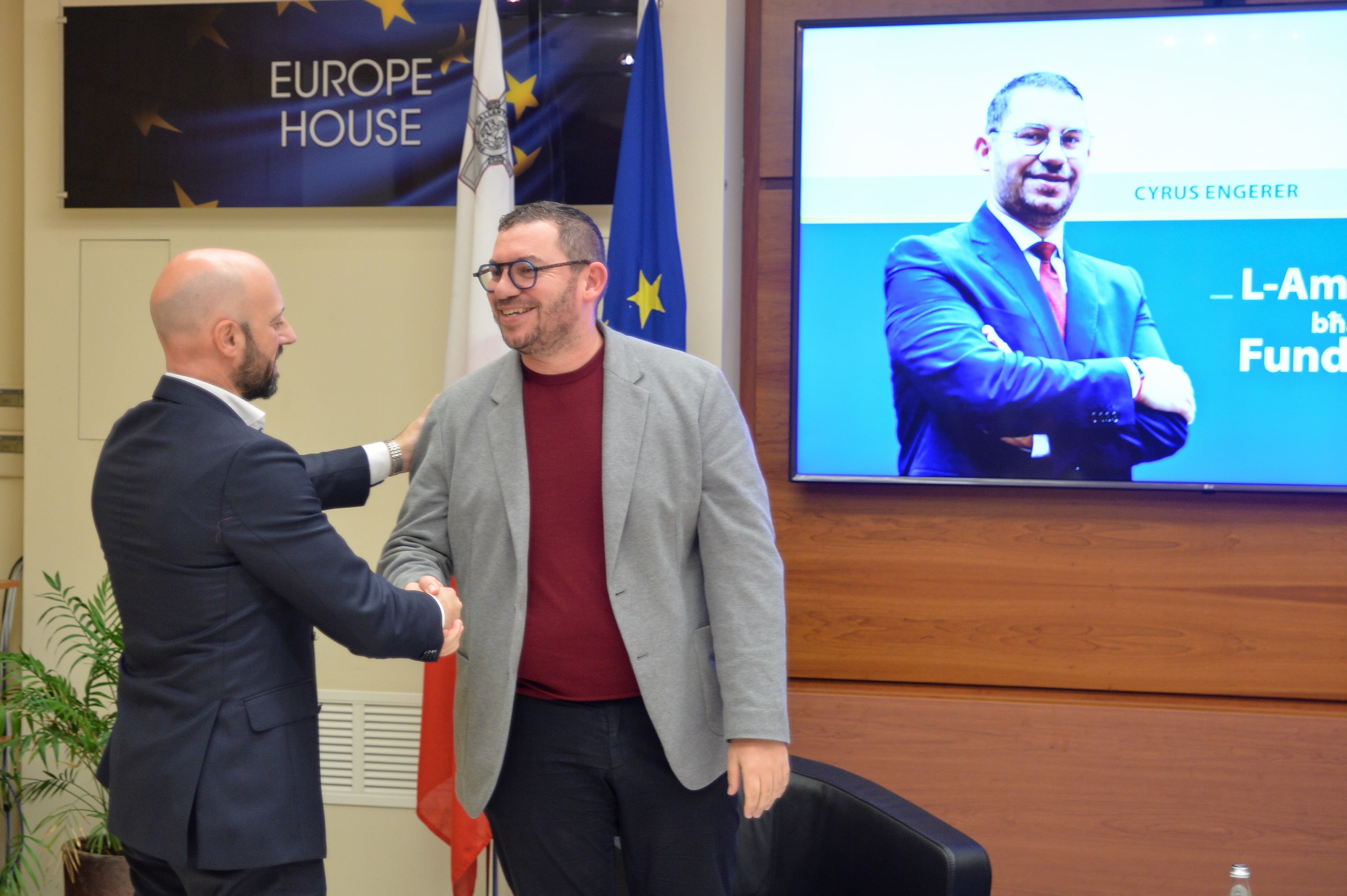 MEP Cyrus Engerer and Dr Mario Sammut shaking hands at "The Environment as a Fundamental Human Right" event