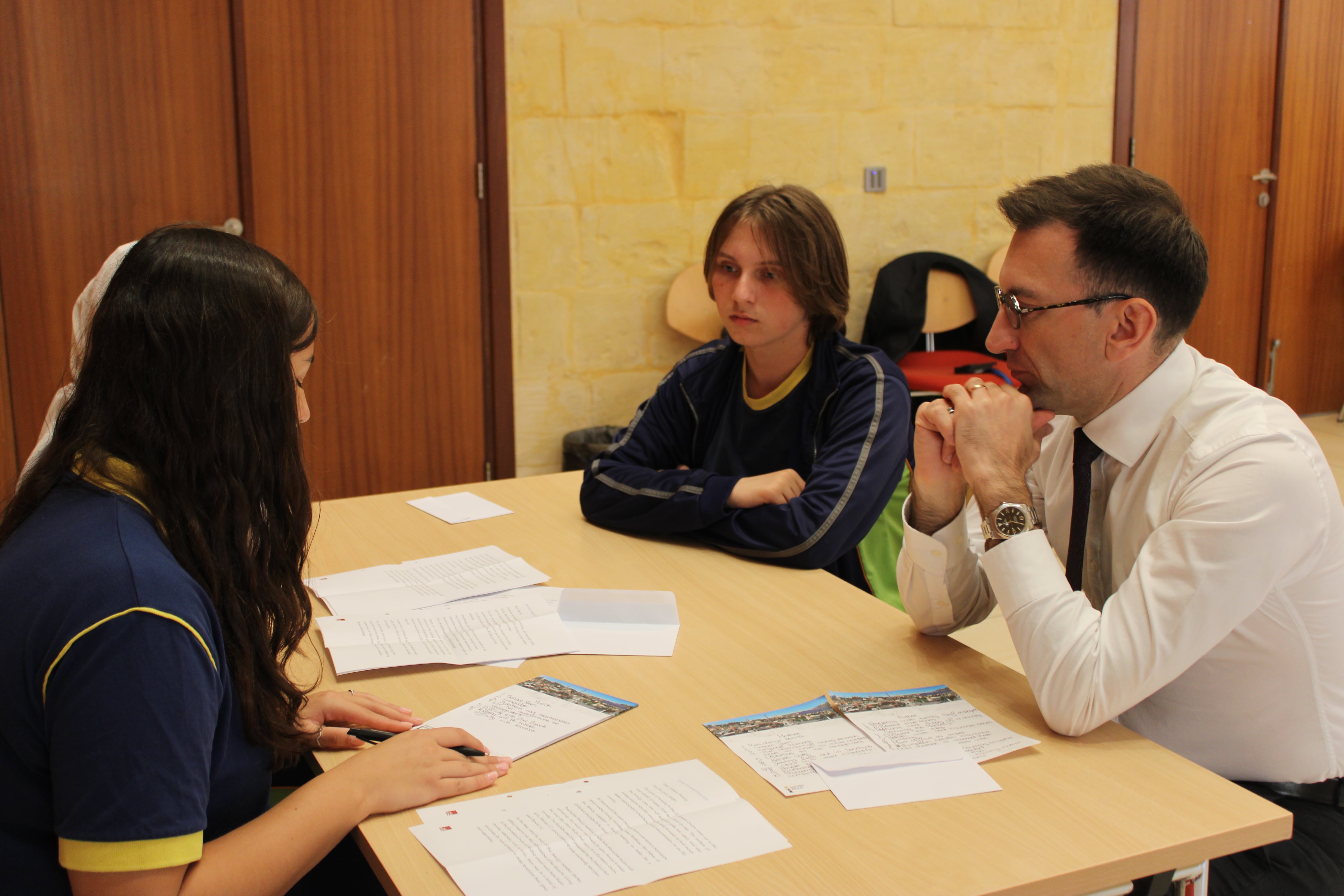 Head of the European Commission Representation in Malta with students discussing the EU simulation game